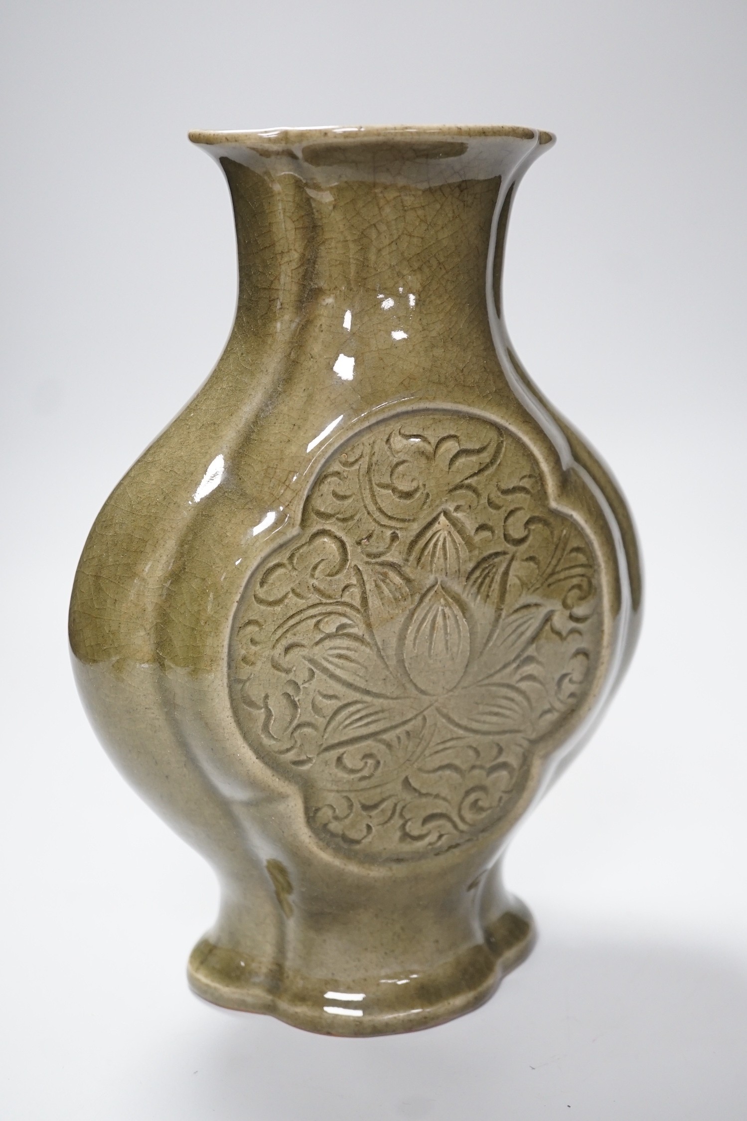 A large Chinese celadon glazed stoneware vase, incised with floral panels, 28cm